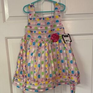 Vibrant Polka Dot Kids Dress with Flower Accent